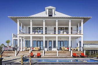 Luxurious white beach house with pool and expansive decks