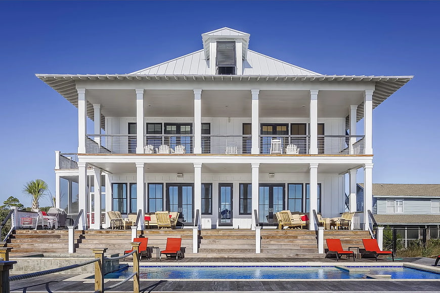 Luxurious white beach house with pool and expansive decks