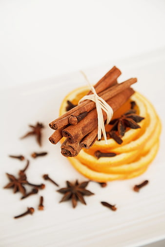 Cinnamon Sticks, Star Anise, and Orange Slices on White