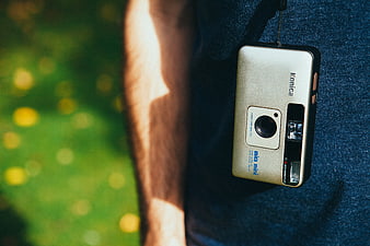 Vintage Konica Film Camera Hanging on Blue Denim