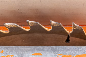 Close-up of circular saw blade teeth on workbench