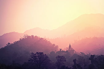 Misty Mountain Landscape with Temple Silhouette at Sunset