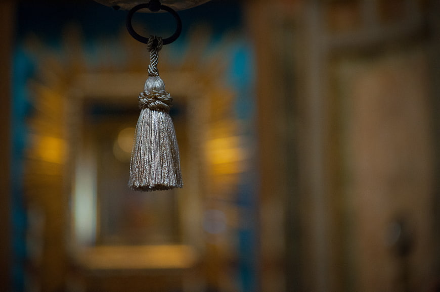 Silver Tassel Hanging in Blurred Church Interior
