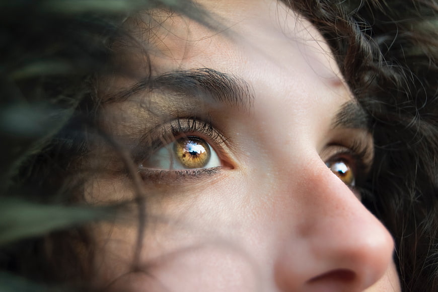 Close-up of woman's hazel eyes with reflection