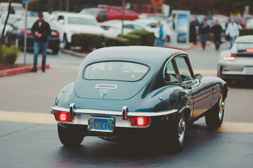 Rear view of classic blue Jaguar E-Type sports car