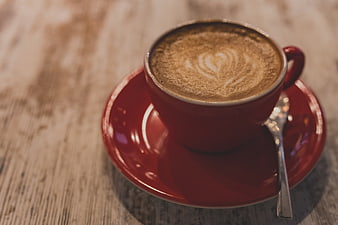 Red Cup of Cappuccino with Heart Latte Art on Wooden Table