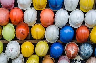 Colorful Construction Hard Hats on Wooden Shelf