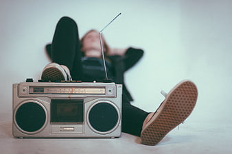 Vintage boombox with woman relaxing in background