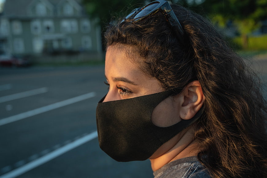 Woman Wearing Black Face Mask in Golden Hour Light