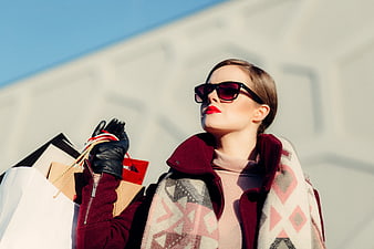 Stylish Woman with Shopping Bags and Sunglasses