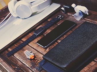 Flat lay of tech gadgets and accessories on wooden table