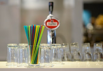 Colorful Straws in Glass with Beer Tap and Glasses