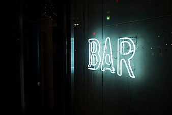 Neon Bar Sign on Dark Wall at Night