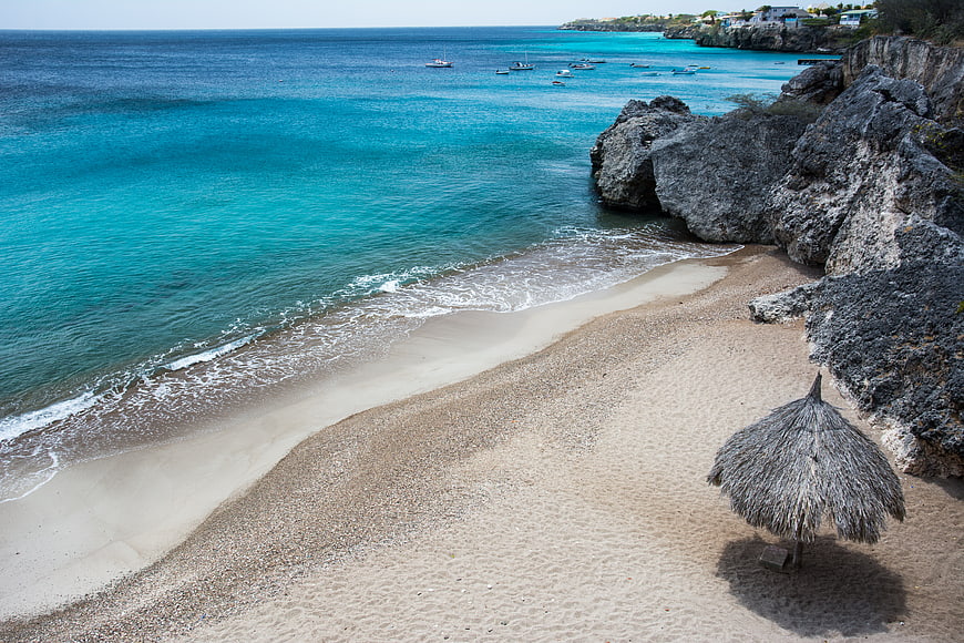 Secluded Caribbean Beach with Turquoise Water and Thatched Umbrella