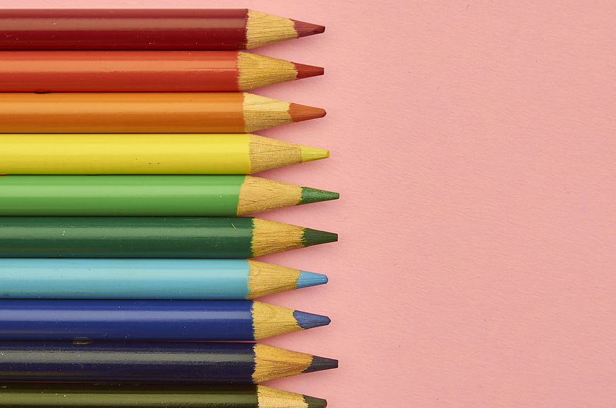 Colorful Pencils Arranged on Pink Background with Copy Space