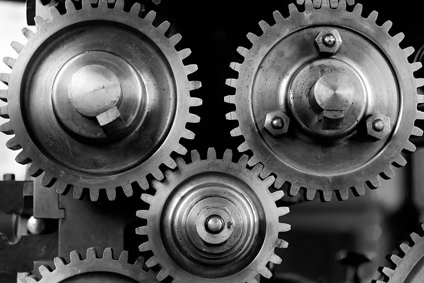 Close-up of interlocking vintage metal gears in black and white