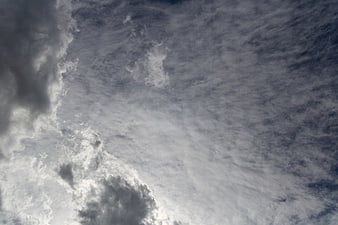 Dramatic moody cloudscape with textured grey and white clouds