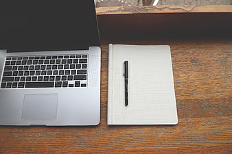 Laptop and Notebook on Wooden Desk Workspace