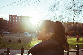 Happy Asian Woman Smiling in Park Sunlight