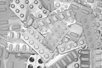 Black and white pile of blister pack pills and tablets