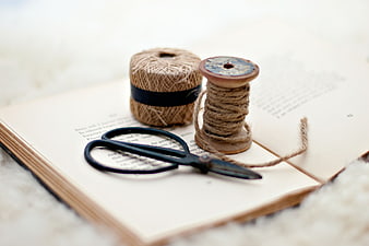 Vintage Scissors and Twine Spools on Open Book