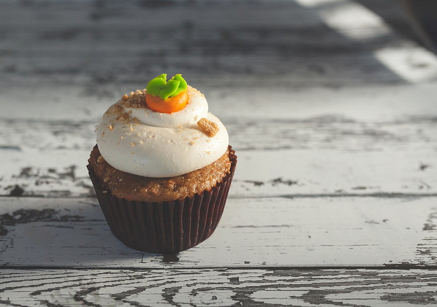 Carrot Cupcake with Cream Cheese Frosting on Rustic Wood
