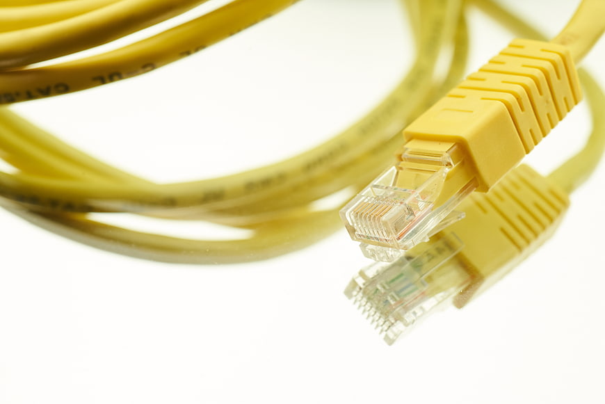 Close-up of yellow ethernet cable connectors on white background