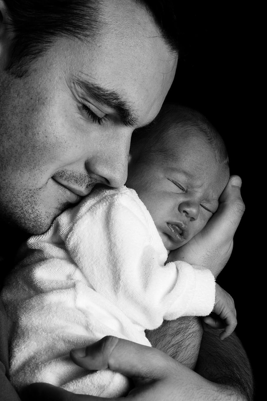 Father Holding Sleeping Newborn Baby Black and White