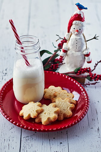 Christmas cookies and milk on red plate with snowman