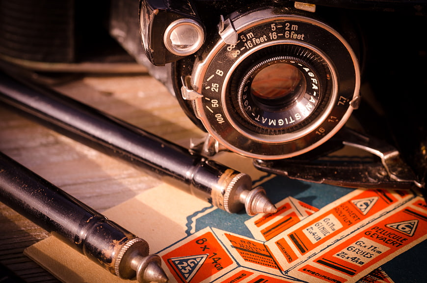 Vintage Agfa Anastigmat Camera and Film Labels on Wooden Table