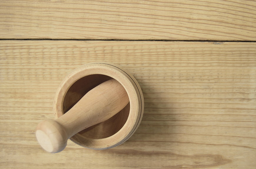 Wooden Mortar and Pestle on Light Wood Table