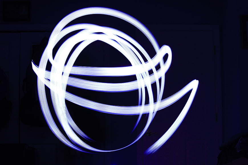 Abstract Blue Light Painting Swirls on Dark Background