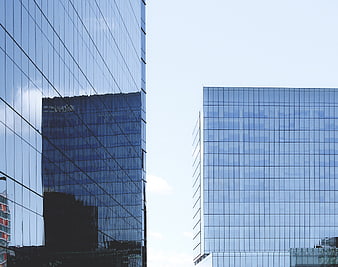 Modern Glass Skyscrapers with Reflections and Blue Sky