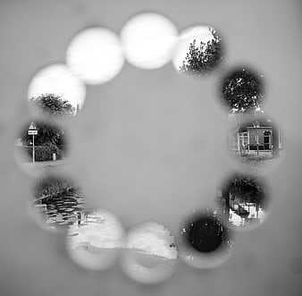 Black and white bokeh circle revealing canal and house scenes