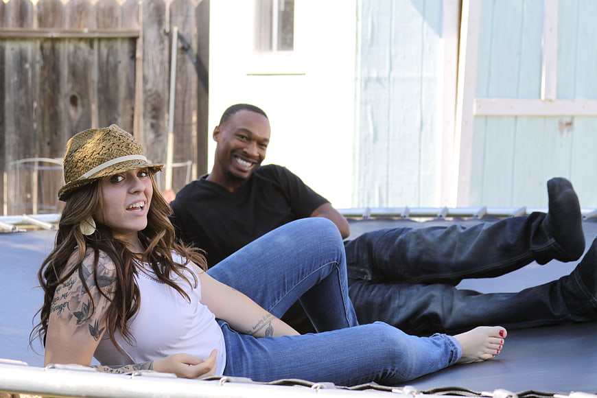 Happy couple relaxing on trampoline outdoors