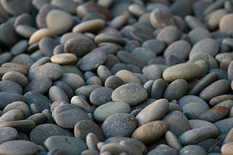 Close-up texture of smooth blue and gray river stones