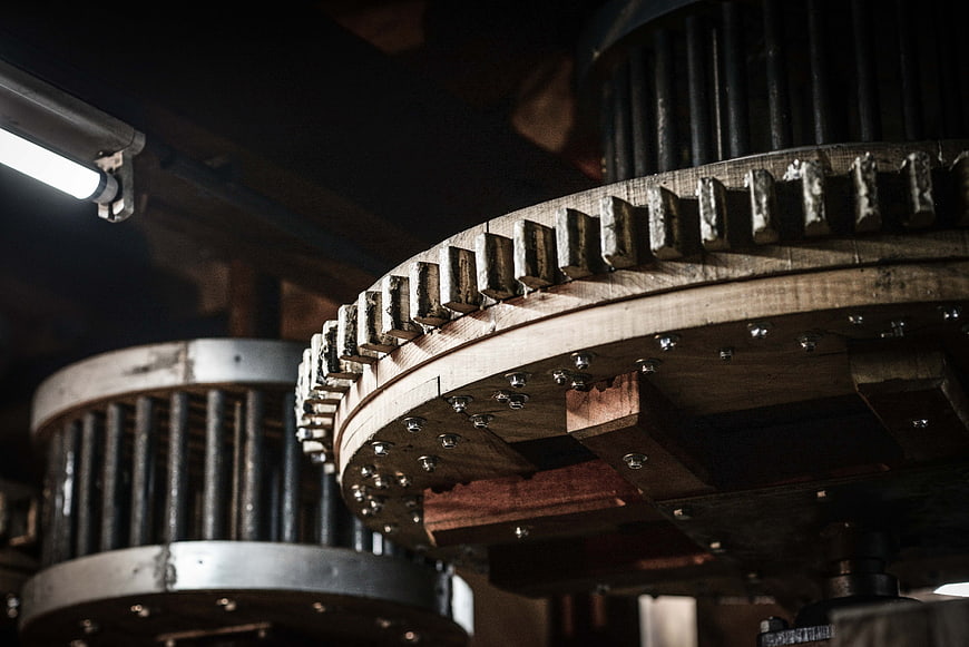 Close-up of large wooden industrial gear mechanism