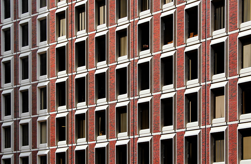 Red Brick Building Facade with Grid of Windows