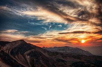 Dramatic Sunset Over Rugged Mountain Peaks