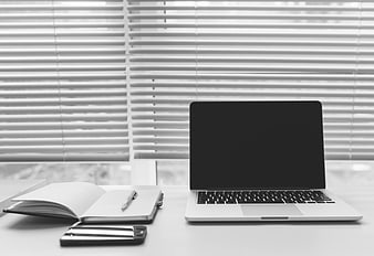 Minimalist Black and White Office Desk with Laptop and Notebook