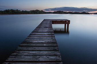 Serene Wooden Dock on Calm Lake at Dusk