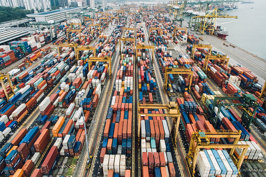 Aerial View of Busy Shipping Port with Containers and Cranes