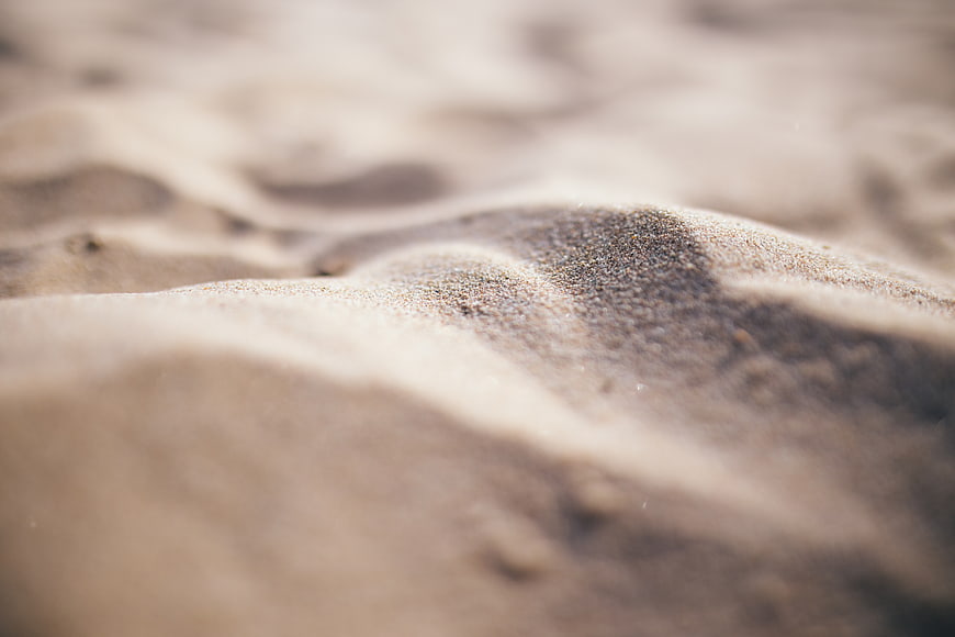 Close-up of textured sand dunes with shallow depth of field