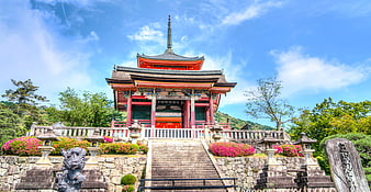 Traditional Japanese Temple on Hillside with Blue Sky