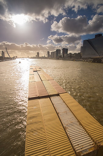 Cargo Ship Containers on River with City Skyline