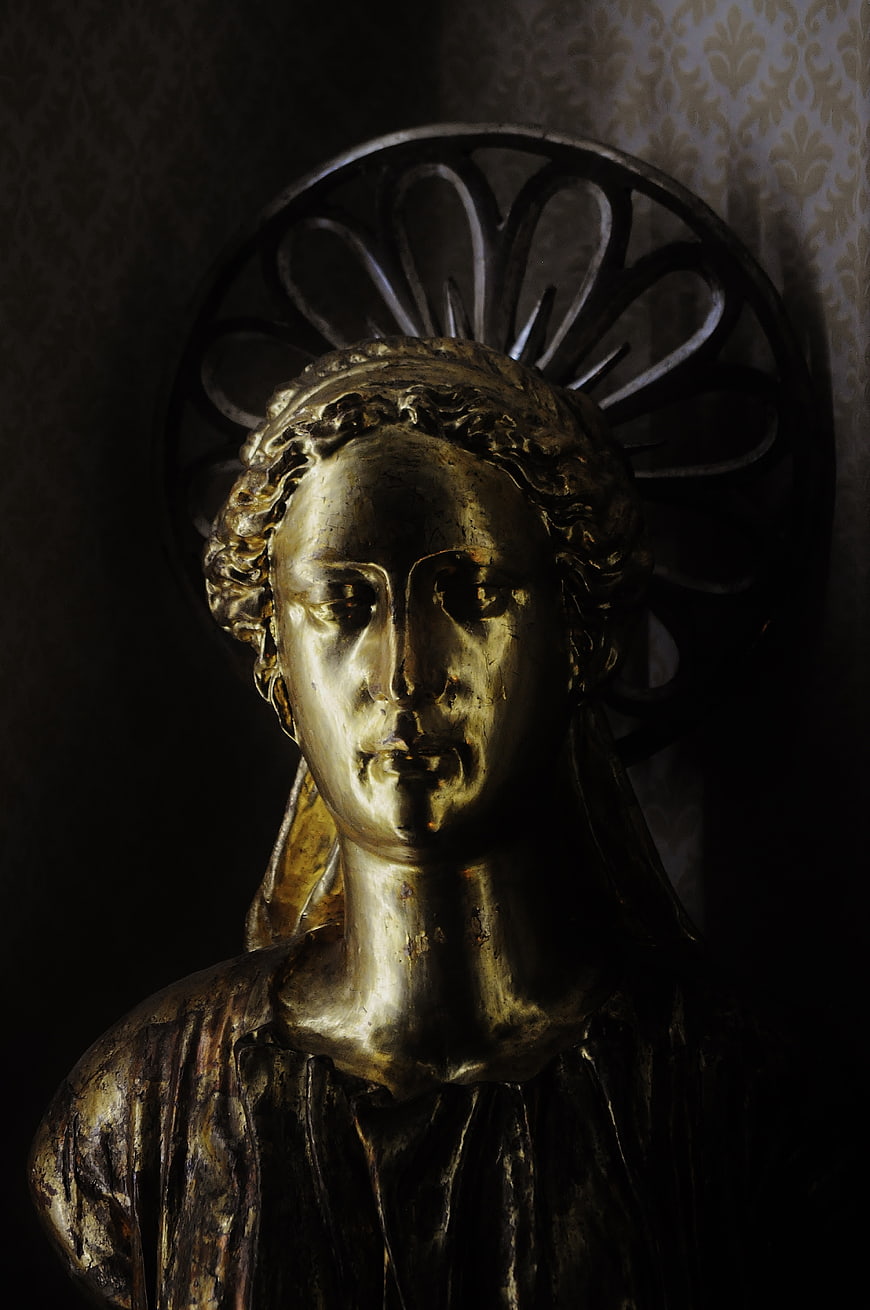 Golden angel statue with halo in dramatic lighting