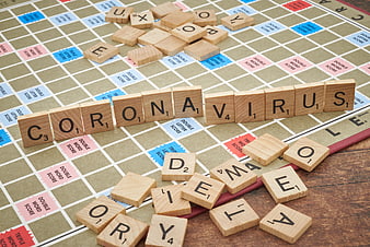 Coronavirus spelled with Scrabble tiles on game board