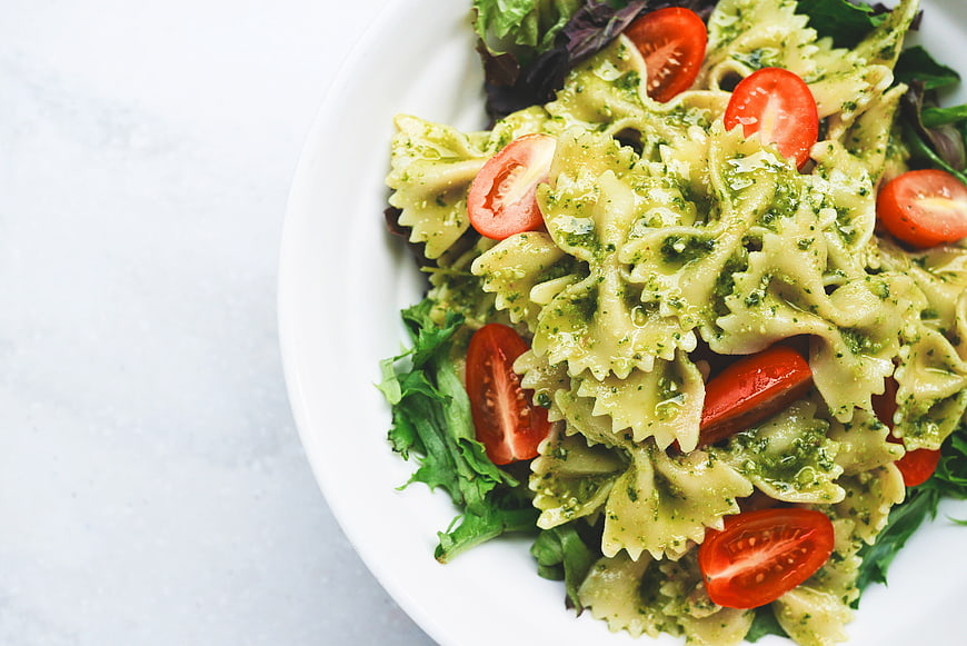 Top View of Pesto Pasta Salad with Cherry Tomatoes