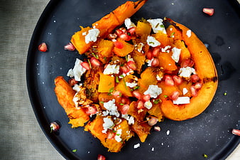 Roasted Pumpkin Salad with Pomegranate and Feta on Black Plate