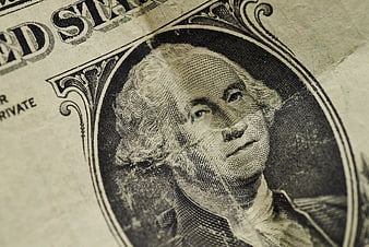 Close-up of George Washington on a worn US one-dollar bill
